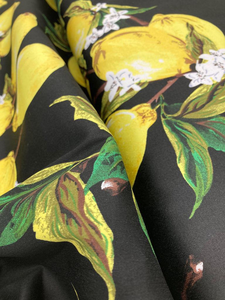 A close up of the lemon fabric. We see the texture of the sateen surface.